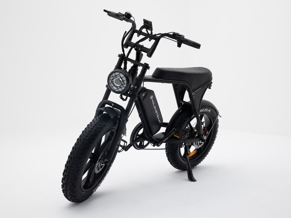 Molenstraat Fatbikes DAPPER electric fatbike in matte black with fat tires, front suspension, and LED headlight.